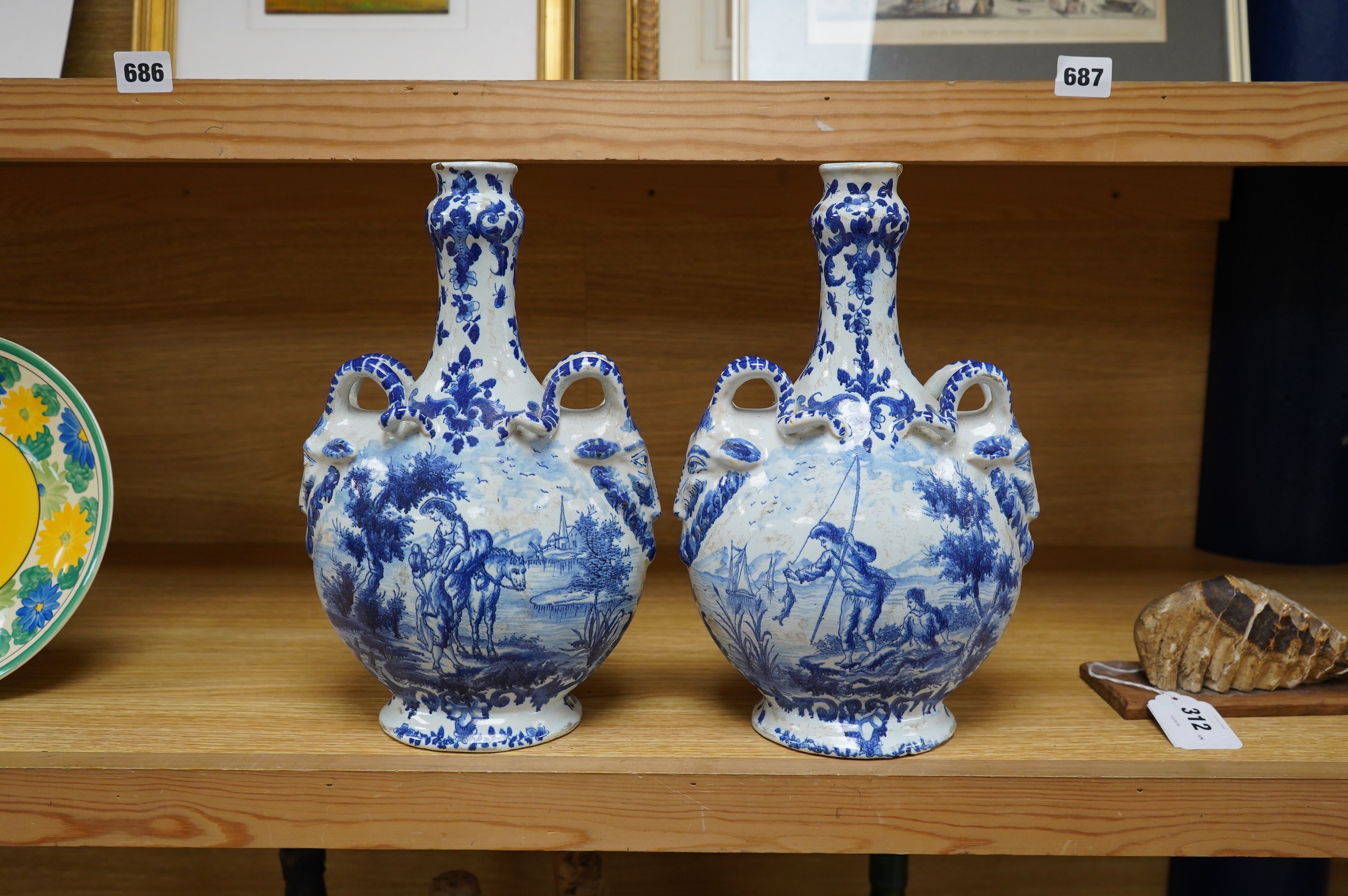 A pair of mid 18th century Delft blue and white flagons